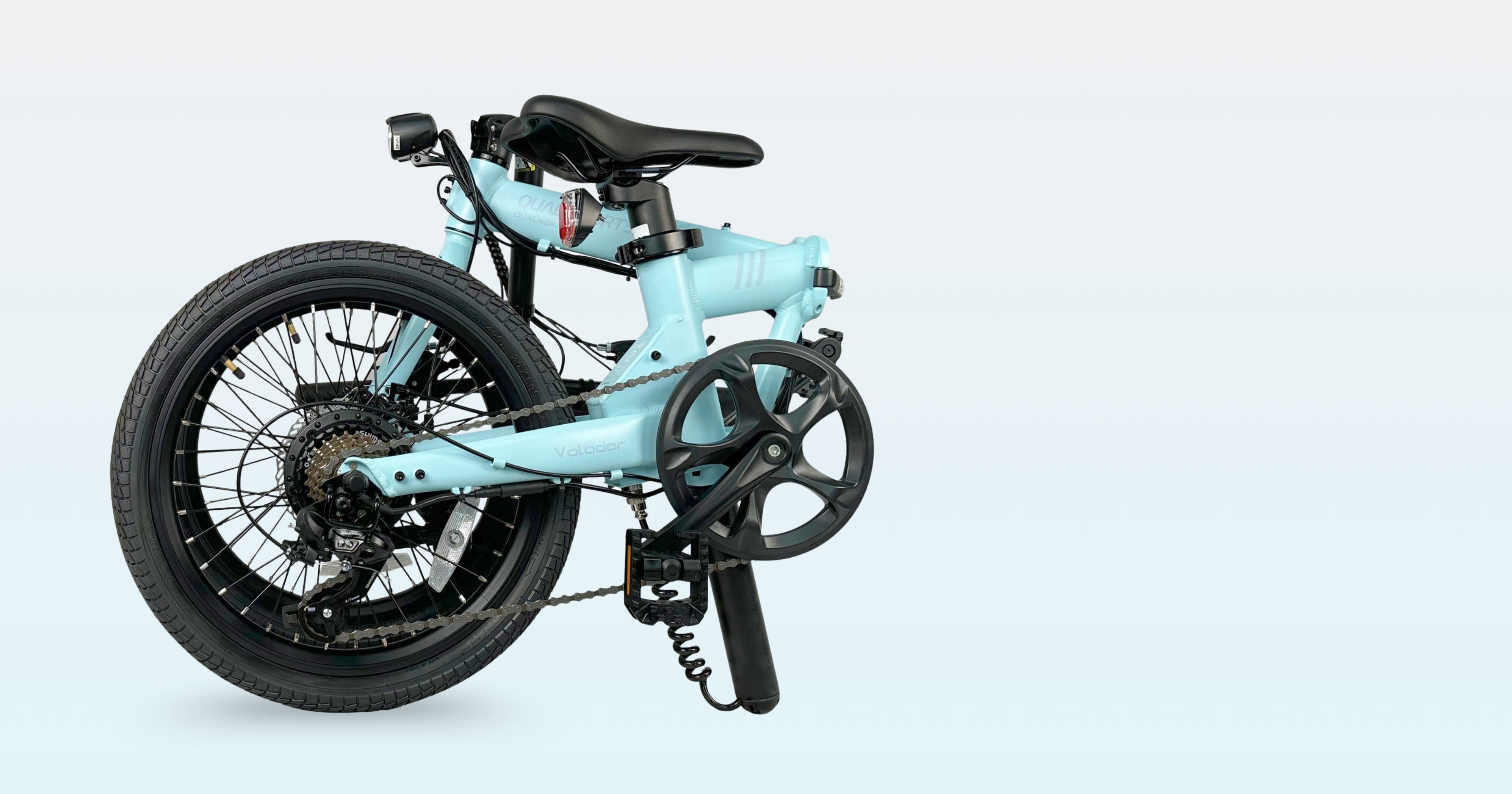 qualisports volador lightweight with Light blue folding electric bicycle on a light gray background