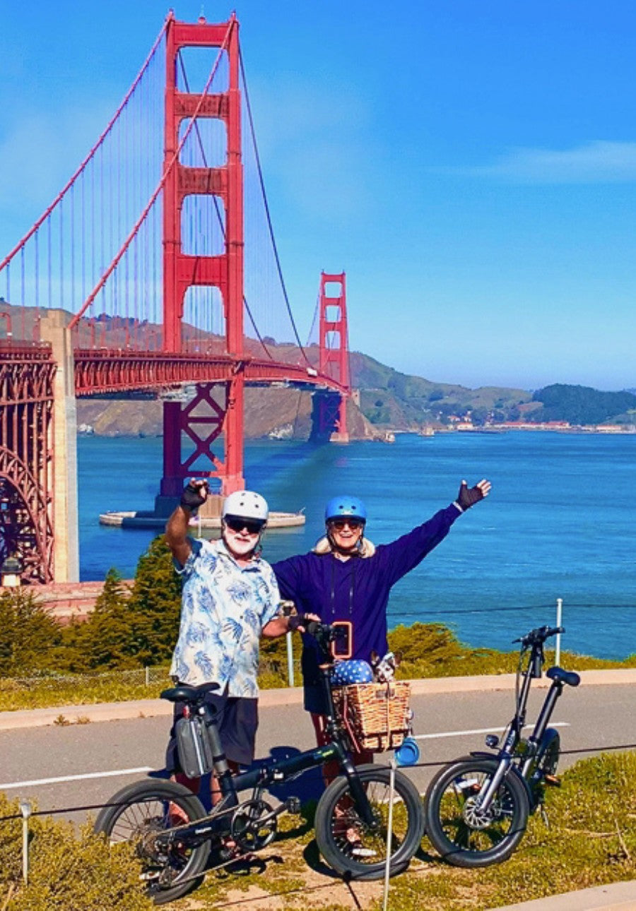 Elderly couple traveling The Golden Gate Bridge with pets on qualisports dolphin folding e-bikes