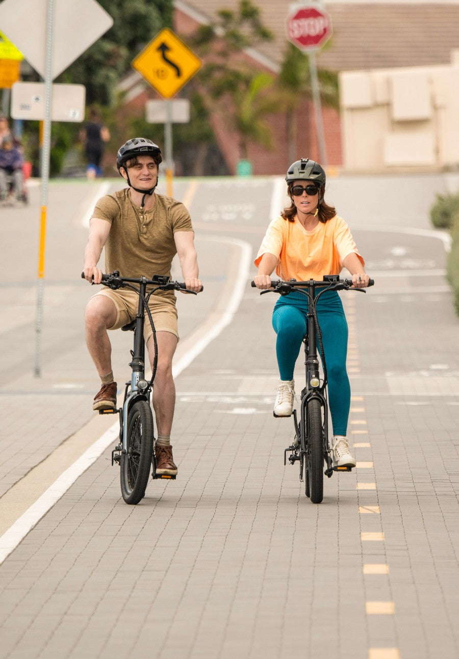 son and mother riding the qualisports folding electric bike