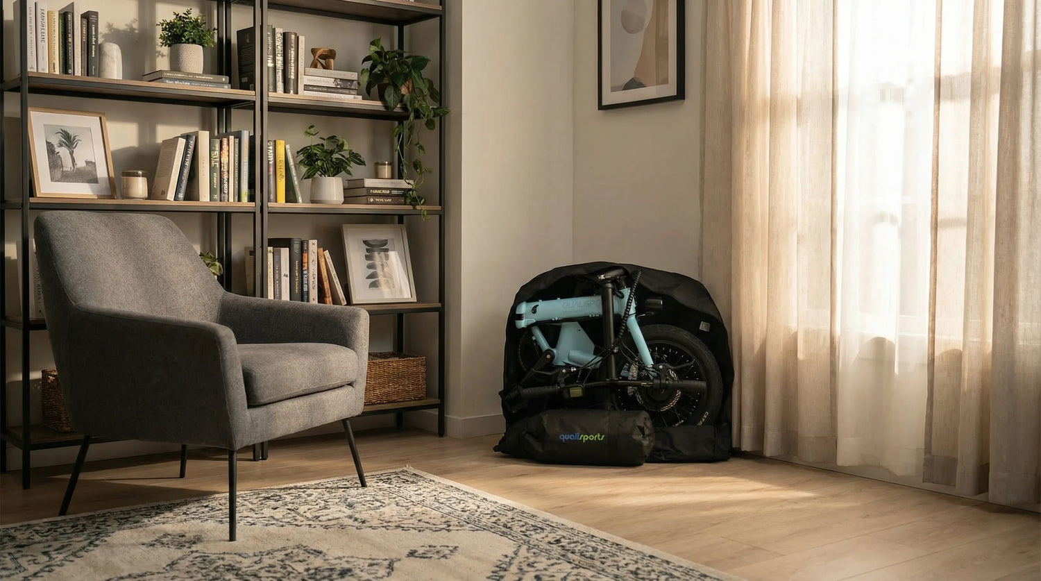 Modern living room with a gray armchair, bookshelf, and a bag with a portable bike inside.
