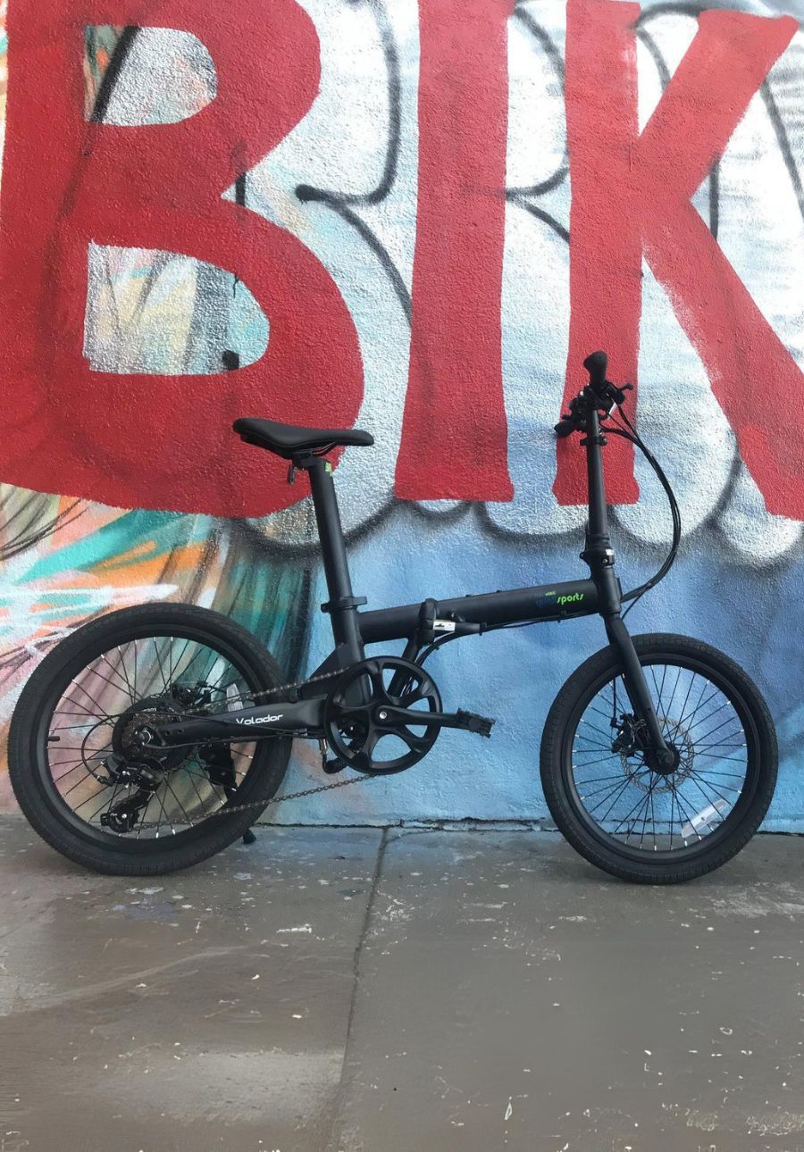 best folding ebike volador 
parked in front of wall with bike graffiti